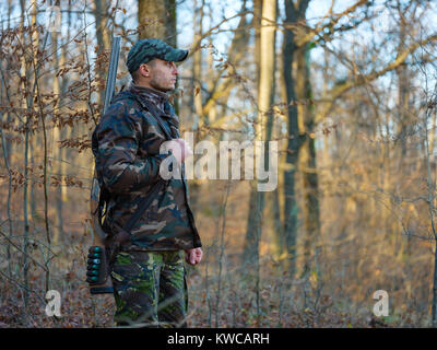 Hunter in camo suit with double barrel shotgun Stock Photo