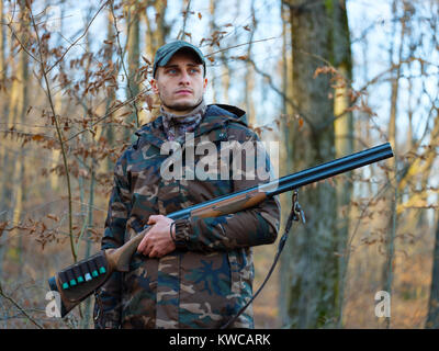 Hunter in camo suit with double barrel shotgun Stock Photo