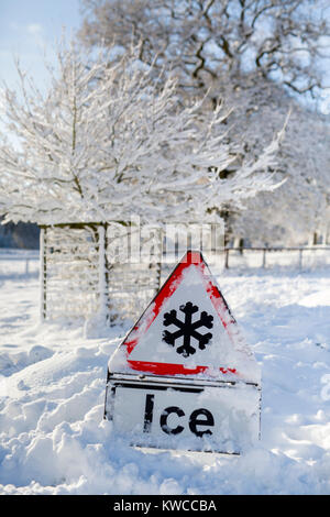 An ice warning sign covered in snow. Stock Photo