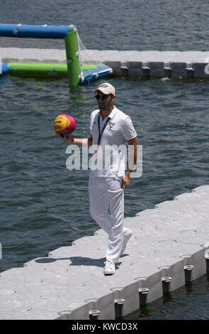 Waterpolo referee wearing white uniform and holding a ball on Cape Town Harbour, Western Cape, South Africa, December 2017. Stock Photo