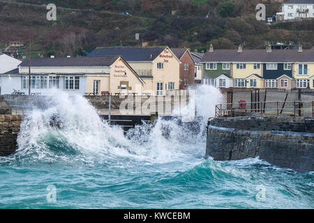 UK weather - stormy sea battering the flood defences at Portreath harbour in Cornwall. Stock Photo