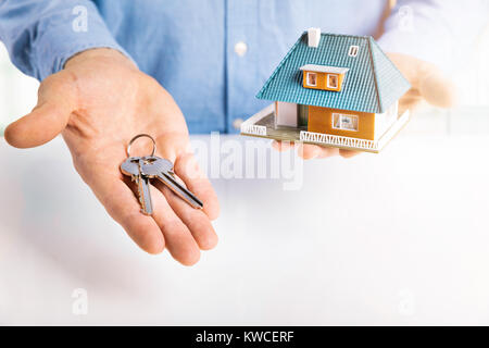 real estate agent with house model and keys in hands Stock Photo