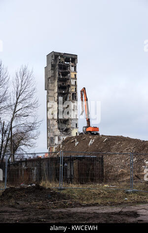 Building demolition with hydraulic excavator Stock Photo