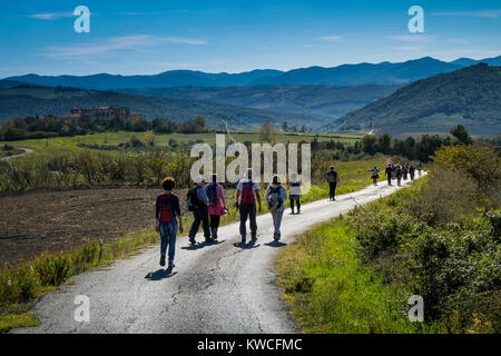 Volterra, Pisa, Italy - November 1, 2017: Hikers depart from Saline for the Volterra hills with panoramic views across the old railway, seen from the  Stock Photo