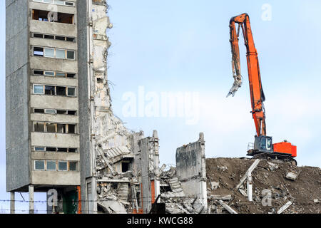 highrise industrial building demolition with hydraulic excavator Stock Photo