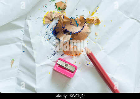 Crayons and debris from the sharpening on white background Stock Photo