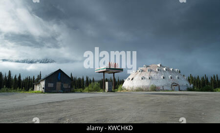 Abandoned gas station in Alaska under a sky with dramatic cloud formation. Stock Photo