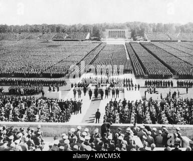 Ranks of the Nazi German army fill Zeppelin Field in Nuremberg. They are addressed by Hitler from a podium (center) during the Nazi Party Congress, Sept. 8, 1938. - (BSLOC 2014 14 10) Stock Photo