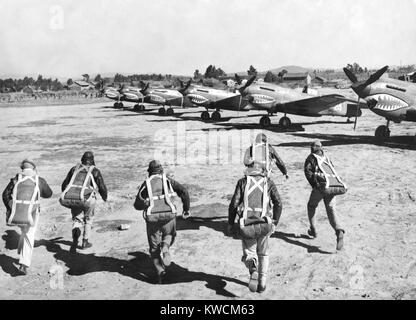 U.S. Flying Tiger pilots run to their fighter planes at an advanced U.S. base in China. They will pursue Japanese bombers conducting an air raid in their area. They are U.S. volunteers recruited and commanded by Claire Lee Chennault from 20 Dec. 20, 1941 through July 4, 1942. - (BSLOC 2014 14 13) Stock Photo