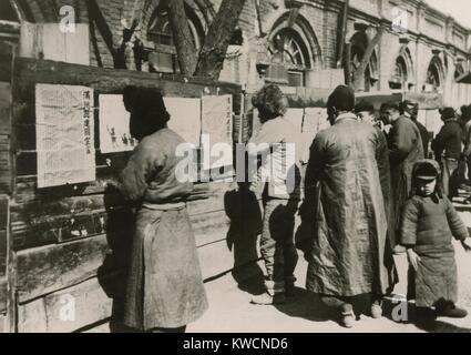 Chinese residents of Manchuria read Japanese announcements. They report establishment of the Republic of Manchukuo with Mr. Henry Pu-Yi, as its chief executive. Japan essentially annexed Manchuria and installed the former child Emperor as its puppet ruler. 1934. - (BSLOC 2014 15 157) Stock Photo