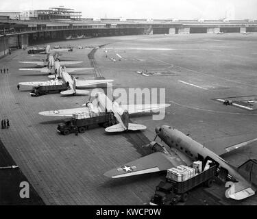 C-47s unloading at Tempelhof Airport during the Berlin Airlift, June-August 1948. In September 1948 they were replaced by larger and faster four-engine C-54s. - (BSLOC 2014 15 245) Stock Photo