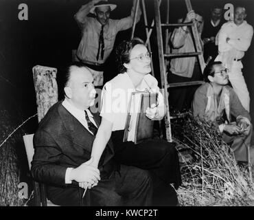 Alfred Hitchcock, seated with Adele Cannon on set of 'Spellbound'. Cinematographer George Barnes is in the background. 1946. - (BSLOC 2014 17 80) Stock Photo