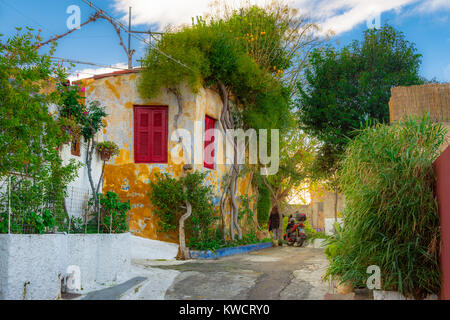 Street of Anafiotika in the old town of Athens, Greece. Anafiotika is district built by workers from the island Anafi. Popular tourist attraction. Stock Photo
