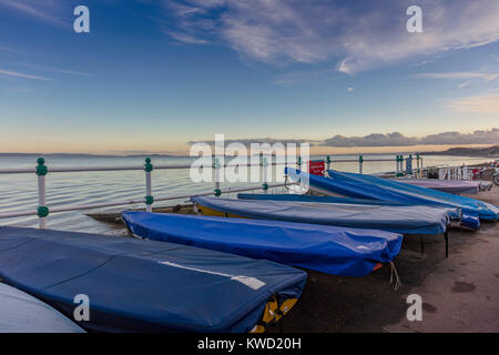 Boats, covered, dry land, looking out over Bristol Channel from Penarth, Vale of Glamorgan, Wales, UK Stock Photo