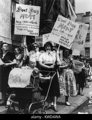 Housewives demonstrate at a meat market in New York City to protest the high cost of meat. At 10th St. and 1st Ave. on Aug. 11, 1948. They advocate a week long boycott of meat purchases. WW2 and Postwar inflation raised prices in USA, but this also reduced the WW2 Nation Debt and set the stage for the economic growth of the 1950s. (BSLOC 2014 13 187) Stock Photo