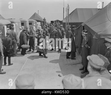 Sick and wounded Korean War POWs are exchanged during Operation Little Switch. UN POW's are off-loaded from ambulances while others in the foreground walk towards tents. Panmunjom, Korea, April-May, 1953. (BSLOC 2014 11 173) Stock Photo