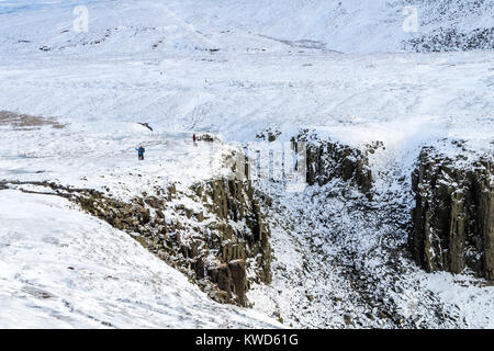 Walkers at High Cup Nick on the Pennine Way in Winter, Cumbria, UK Stock Photo