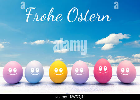 Colorful Easter eggs on a wooden board with the happy Easter lettering Stock Photo