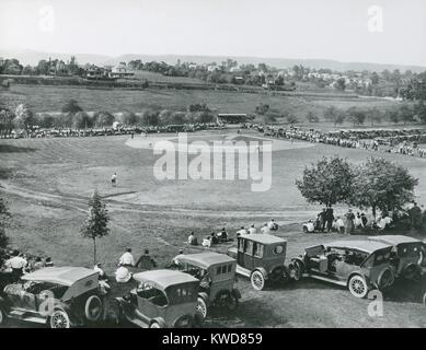 Baseball game at Seibert Field, Massanutten Academy, Woodstock, Virginia, 1922. Spectators watch the game from a grandstand while others watch from cars in the far outfield. (BSLOC 2015 17 1) Stock Photo