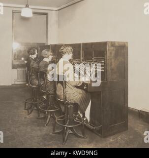 Three female telephone switchboard operators in the Quotation Room of New York Stock Exchange. Until the 1960s when direct long distance dialing was introduced, thousands of women were employed to connect calls by inserting a pair of phone plugs into the appropriate jacks (BSLOC 2016 10 40) Stock Photo