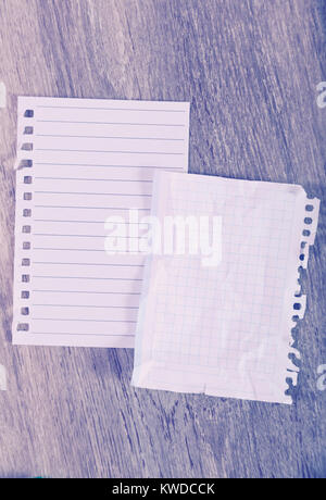 Torn sheets in notebook on table Stock Photo