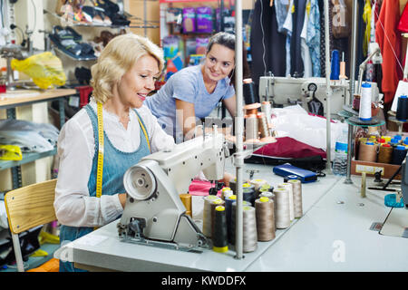 Portrait of two professional experienced female tailors working in the sewing workshop Stock Photo