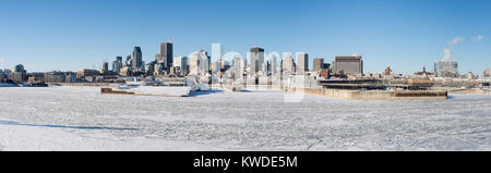 Montreal, CA - 1 January 2018: Montreal Skyline and Frozen St Lawrence River in winter Stock Photo