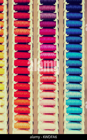 closeup view on multicolored stitching spools in sewing shop Stock Photo