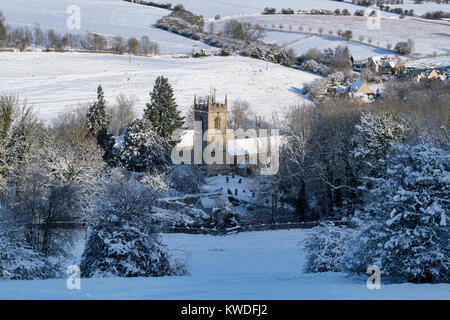 St Andrews Church, Naunton village in the snow in December. Naunton, Cotswolds, Gloucestershire, England Stock Photo