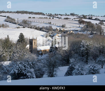 St Andrews Church, Naunton village in the snow in December. Naunton, Cotswolds, Gloucestershire, England Stock Photo