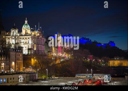 The Bank of Scotland HQ on the Mound and Edinburgh castle illuminated in blue during the new year celebrations. Stock Photo