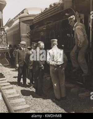 President Theodore Roosevelt talking with railroad workers, April-June 1906. Standing beside the coal car, the group includes locomotive operators and conductors. Unidentified location (BSLOC 2017 6 62) Stock Photo