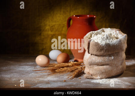 Closeup shot of flour in sack on rustic wooden table. Stock Photo