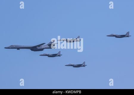 US Air Force B-1B Lancer, escorted by South Korean air force F-15K Slam Eagles, Sept. 13, 2016. The allied aircraft fly over Osan Air Base, South Korea, Sept. 13, 2016 (BSLOC 2017 18 182) Stock Photo