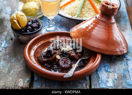 Slow cooked beef with prunes, figs, raisins and almonds - moroccan tajine. Stock Photo