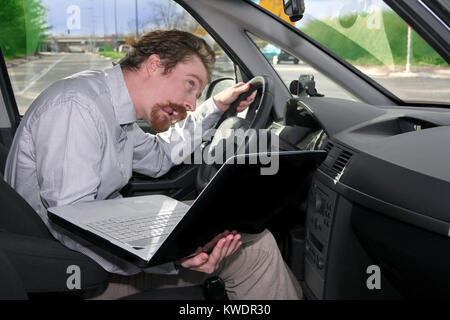 driver using GPS laptop computer in a car Stock Photo
