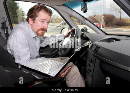 driver using gps laptop computer in a car Stock Photo