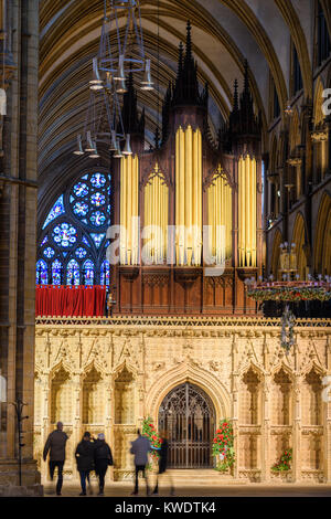 Stone rood screen and organ pipes at the christian cathedral built by the norman conquerors in the eleventh century at Lincoln, England. Stock Photo