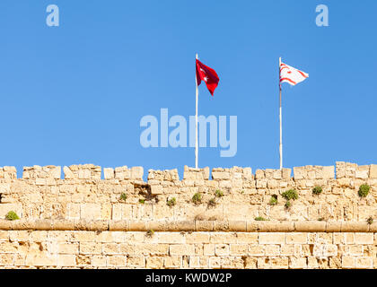The flags of Turkey and the Turkish Republic of Northern Cyprus fly above Kyrenia Castle in Northern Cyprus. Stock Photo