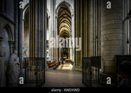 The gothic interior of the historic Rouen Cathedral in Normandy France with dramatic lighting and vaulted ceiling Stock Photo