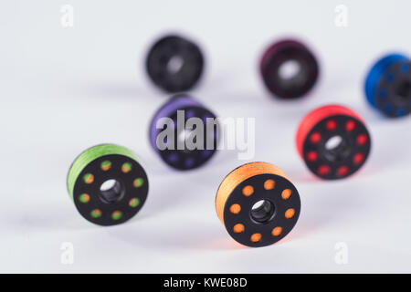 metal sewing rollers and colored yarns Stock Photo