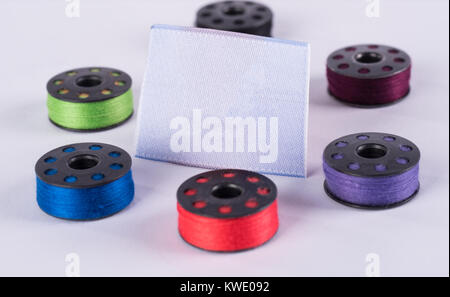 metal sewing rollers and colored yarns Stock Photo