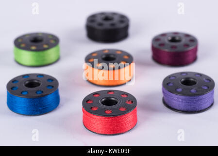metal sewing rollers and colored yarns Stock Photo