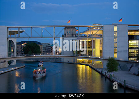 The government area in Berlin, in the background the Reichstag. In front the Spree river with one of the many sightseeing boats. Stock Photo