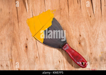 yellow paint on spatula Stock Photo