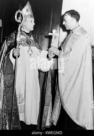 14th June 1944.The Right Reverend William T. Manning, Bishop of the Protestant Episcopal diocese of New York, presents a silver cross to the very Reverend Doushan J. Shoukletovich, dean of the Cathedral of St. Sava, in New York City, they first Serbian Orthodox Cathedral to be established in the US. The presentation was part of the dedication ceremony of the church in which thousands of Americans and Canadians of Serbian descent participated. Stock Photo