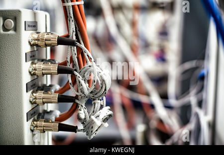 Electric cables connecting machines with control device used in industry Stock Photo