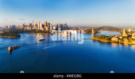 Mid-air view over Sydney harbour shore to city CBD landmarks, Fort Denison and passenger ferry to manly on a sunny summer day. Stock Photo