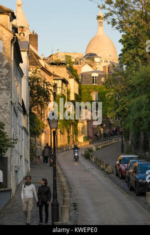 France, Paris, Couple walking down street with Sacre Coeur, Montmartre Stock Photo