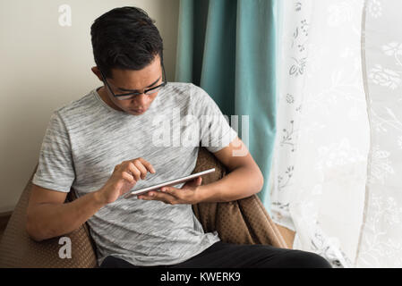 asian teen using digital tablet at home. social lifestyle concept Stock Photo